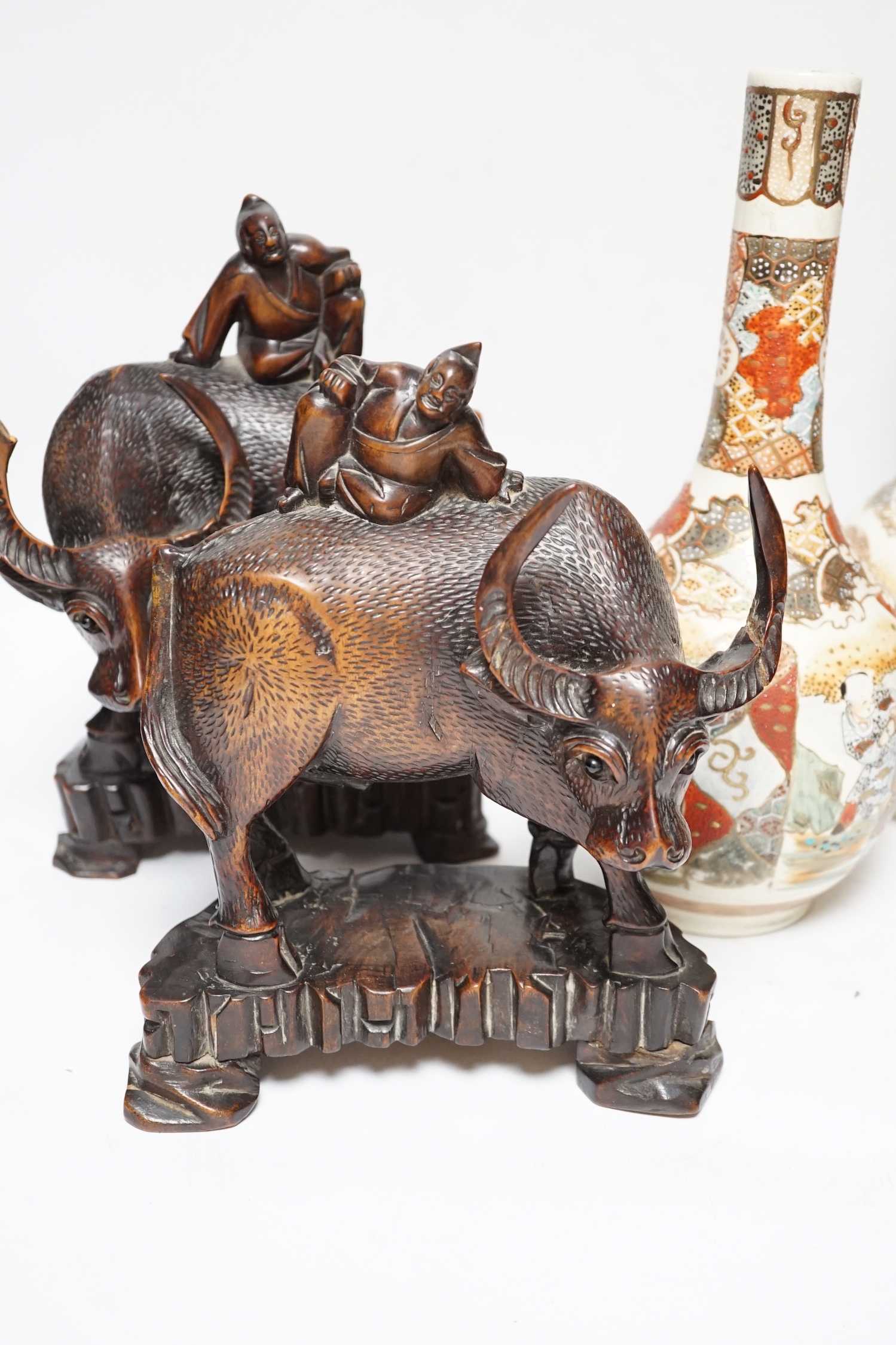 A pair of Japanese Satsuma vases and a pair of Chinese carved figural ox groups, carvings 25cm high